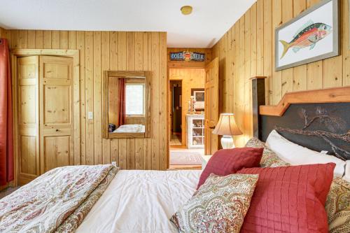 a bedroom with a bed and a wooden wall at Idyllic Remer Cabin with On-Site Lake Access! in Remer