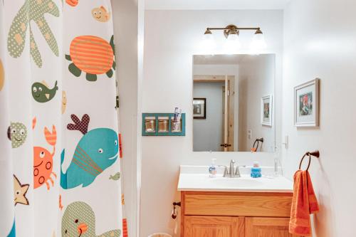 a bathroom with a sink and a mirror at Idyllic Remer Cabin with On-Site Lake Access! in Remer