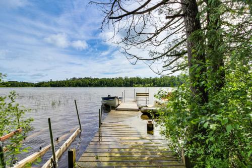 a dock with a boat on a lake at Idyllic Remer Cabin with On-Site Lake Access! in Remer