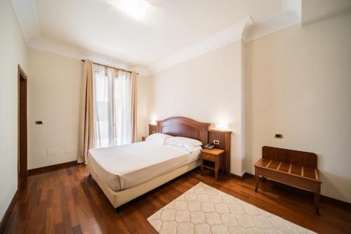 a bedroom with a bed and a table and a window at Antica Masseria Martuccio in Mesagne