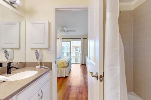 a bathroom with a sink and a bed in a room at The Palm Bay Club Unit 311 in Siesta Key