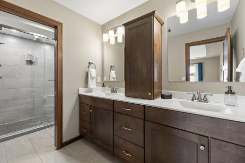 a bathroom with a sink and a mirror and a shower at Ponderosa Mile in Rapid City