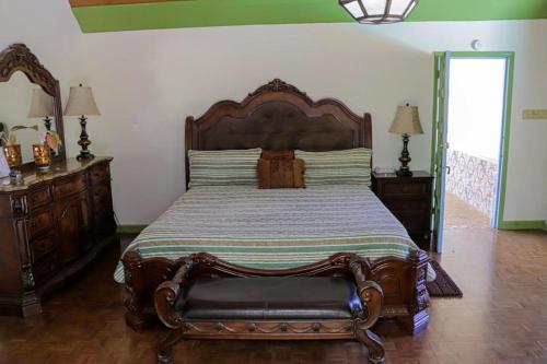 a bedroom with a large bed with a wooden headboard at Seven Palms Villa in Runaway Bay