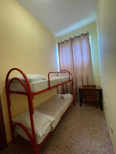 a small room with two bunk beds and a table at Hotel Bed & Breakfast Minu' in Paravati