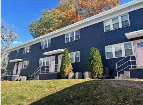 a blue building with trees in front of it at Davenport Dwellings-Two Bedroom Close to UNMC in Omaha