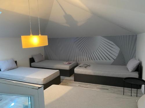 a room with two beds and a table at Villa La Familia in Bihać