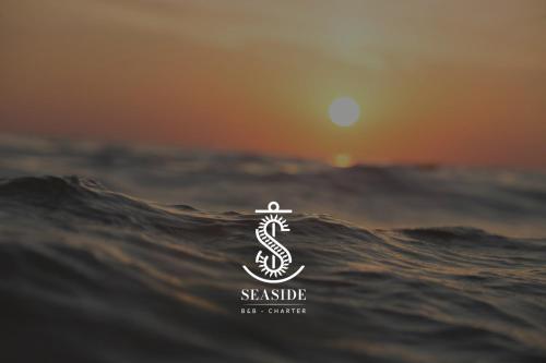 a seattle food center logo on a wave in the ocean at SEASIDE Bed and Breakfast in Praia a Mare