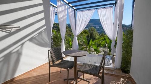 a table and chairs on a balcony with a view at Ada Port Hotel Adults Only in Alanya
