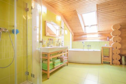 a bathroom with a shower and a sink and a tub at Lomnický Zrub in Veľká Lomnica
