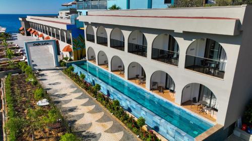an overhead view of a building with a swimming pool at Ada Port Hotel Adults Only in Alanya