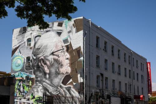a building with a mural of a man on it at American Hotel in Los Angeles
