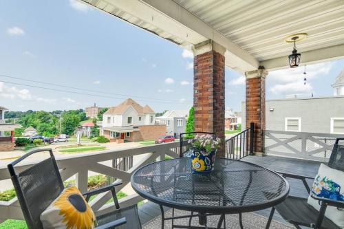 a patio with a table and chairs on a balcony at The Big House in Jefferson City