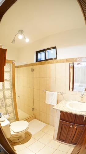 a bathroom with a toilet and a sink at Villas Welcome to Heaven in Carrillo