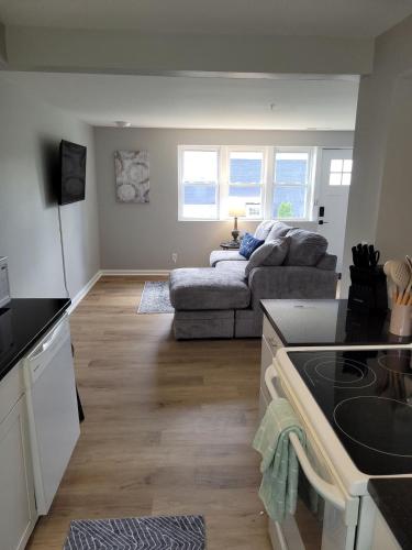 a kitchen and a living room with a couch at Davenport Dwellings 2 Bd by UNMC in Omaha
