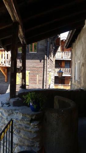 a porch of a building with a potted plant at Historische Maisonettewohnung bis 10 Gäste, Magic Pass Belalp, Rosswald und mehr in Naters