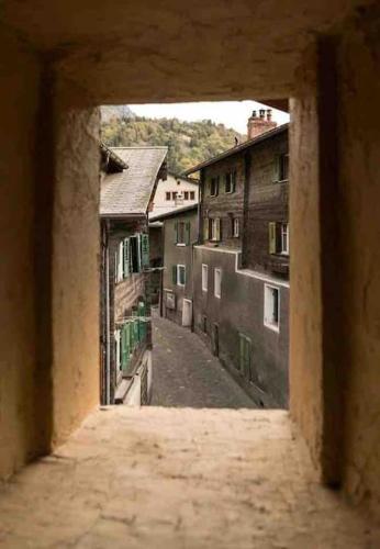 a view of an alley from an old building at Historische Maisonettewohnung bis 10 Gäste, Magic Pass Belalp, Rosswald und mehr in Naters