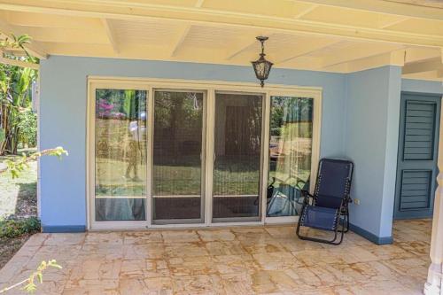 a chair sitting on a porch of a house at Seven Palms Villa in Runaway Bay