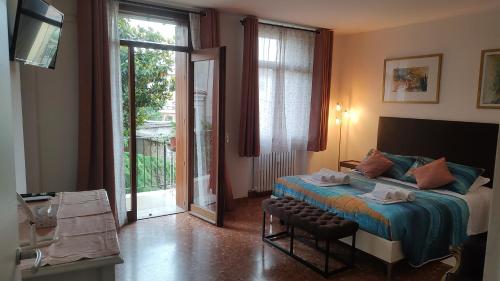 a bedroom with a bed and a sliding glass door at Verona Relax & Stay APARTMENTS in Verona