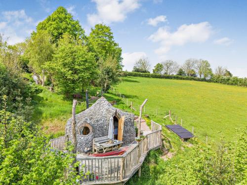 an exterior view of a stone house in a field at HOBLEY House Holiday in Craven Arms