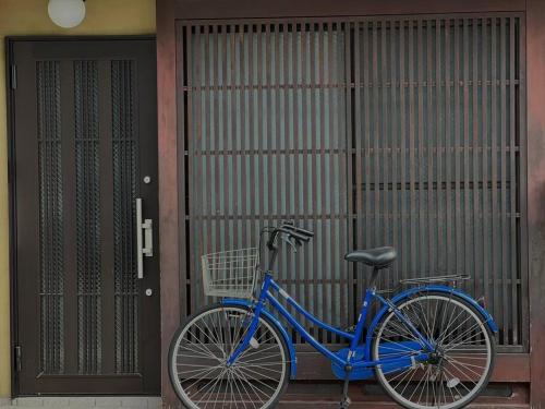 a blue bike parked in front of a building at 木木町屋 mumu Machiya Kyoto in Kyoto