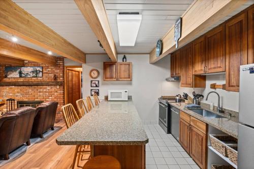 a kitchen with wooden cabinets and a counter top at Chateau DuMont 05 in Aspen