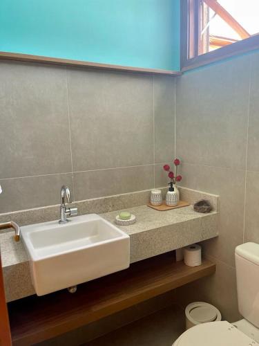 a bathroom with a sink and a toilet at Villagio Di Mare in Marau