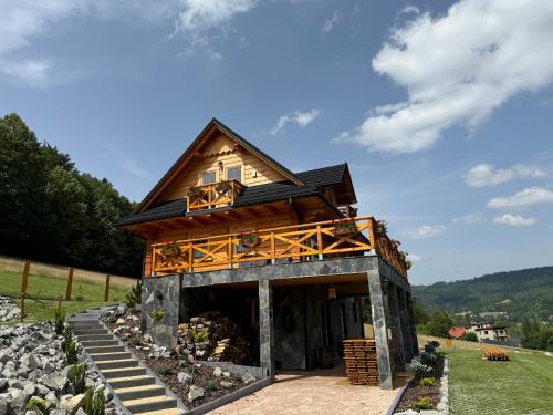 a house on top of a hill with a building at Chata Trzy Wierchy in Wisła