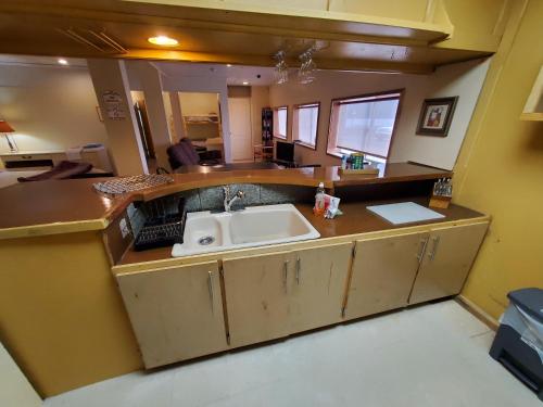 a kitchen with a sink and a counter top at Orca Inn in Alert Bay