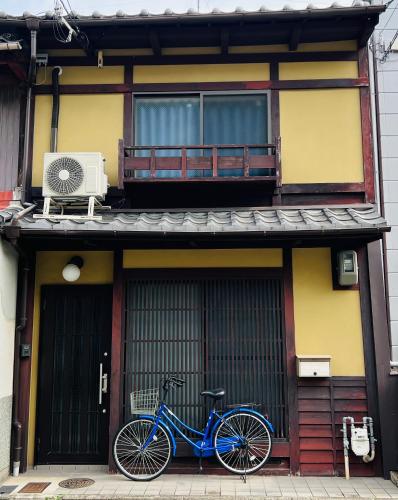 a blue bike parked in front of a building at 木木町屋 mumu Machiya Kyoto in Kyoto