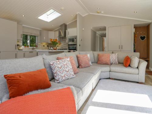 a living room with a gray couch with colorful pillows at Waterside Lodge in Windermere