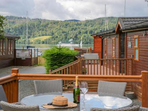 a deck of a cabin with a table and chairs at Waterside Lodge in Windermere