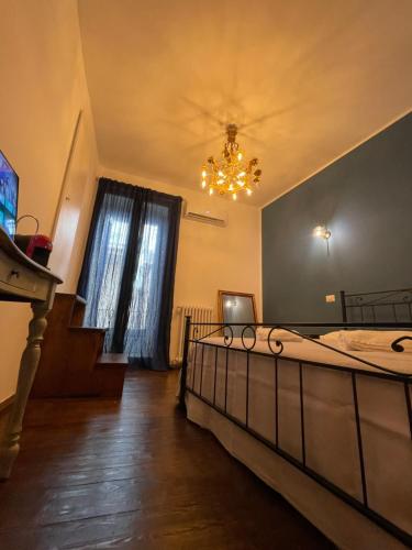 a bedroom with a large bed and a chandelier at Il Serafino Holiday Suites in Bari