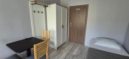 a room with a desk and a table and a bed at Sejf House in Gdańsk