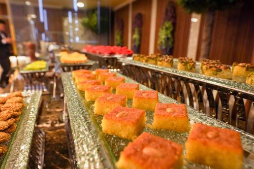 a buffet line with many different types of food at Grand Villaggio Hotel Abu Dhabi in Abu Dhabi