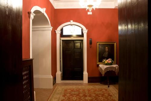 a hallway with a black door and a portrait of a man at Appartamento Ca' Cavalli in Venice
