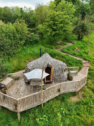 a wooden deck with a table and a tent at HOBLEY House Holiday in Craven Arms