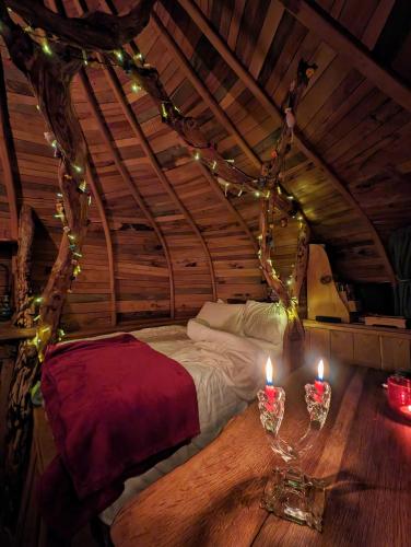 a room with a bed and candles on a table at HOBLEY House Holiday in Craven Arms