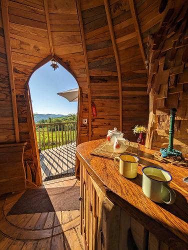 a kitchen with a counter in a wooden cabin at HOBLEY House Holiday in Craven Arms