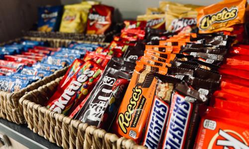 a bunch of candy bars in baskets on a table at The Principal Hotel in Columbia