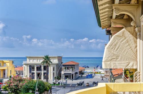 a view of a city with the ocean and buildings at Hotel Playa in Viareggio
