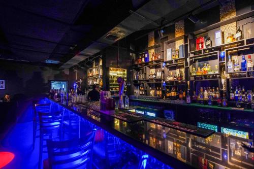 a bar filled with lots of bottles of alcohol at Grand Villaggio Hotel Abu Dhabi in Abu Dhabi