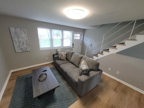 a living room with a couch and a table at Davenport Dwellings 10- By UNMC in Omaha