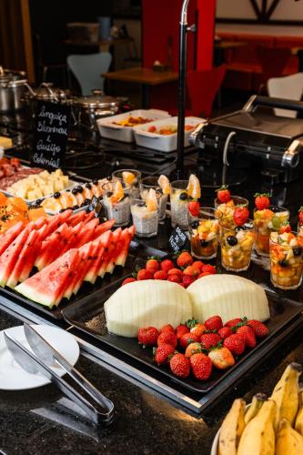 a buffet with many different types of food on a table at ibis Blumenau in Blumenau