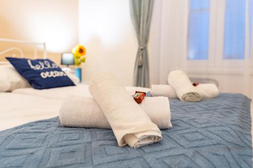 a bedroom with two towels on a bed at Rooms Nona Albina in Rab