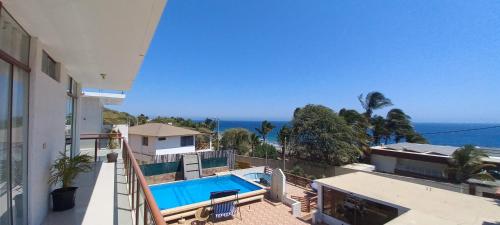 a balcony of a house with a swimming pool at LA COLINA Casa-Hospedaje in Máncora