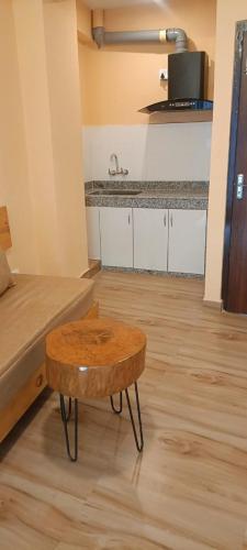 a living room with a coffee table and a kitchen at Tourist Apartment Baluwatar in Kathmandu