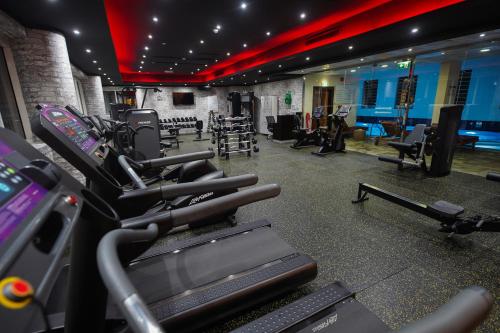 a gym with a bunch of treadms and machines at Grand Villaggio Hotel Abu Dhabi in Abu Dhabi