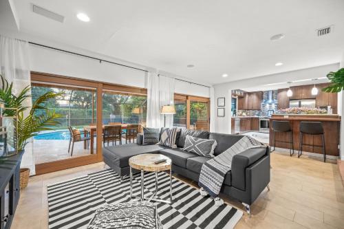 a living room with a couch and a table at Family Beach Home With Home Theater & Heated Pool! in Hollywood