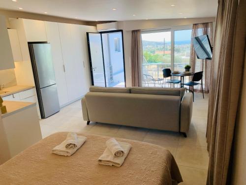 a large living room with a couch and a table at Thelfi Luxury studio in Attica - close to varkiza beach - Sea view in Vari