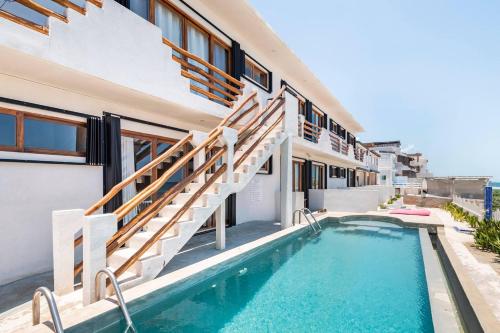 a villa with a swimming pool and a house at Villas Najo' Isla Mujeres. in Isla Mujeres